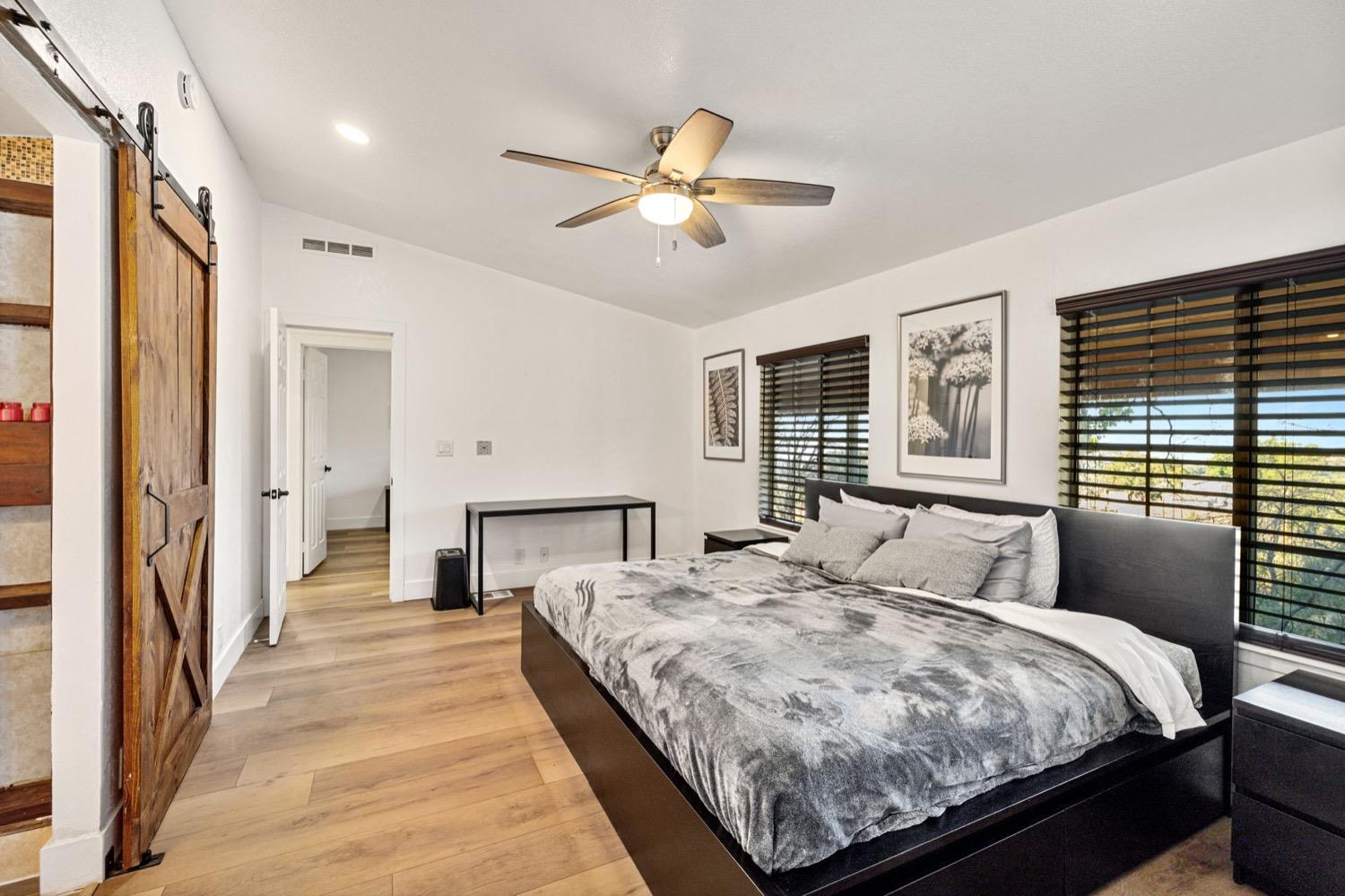 36696 Peterson Road Auberry, CA 93602 - Photo 17 of 34 a bedroom with a large bed and a chandelier