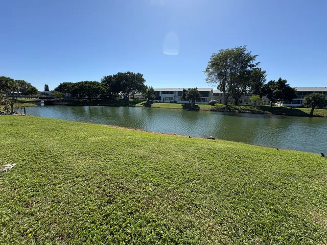 a view of a lake with houses in the back