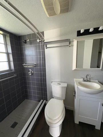 a bathroom with a sink toilet and shower