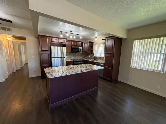 a view of kitchen with cabinets and wooden floor