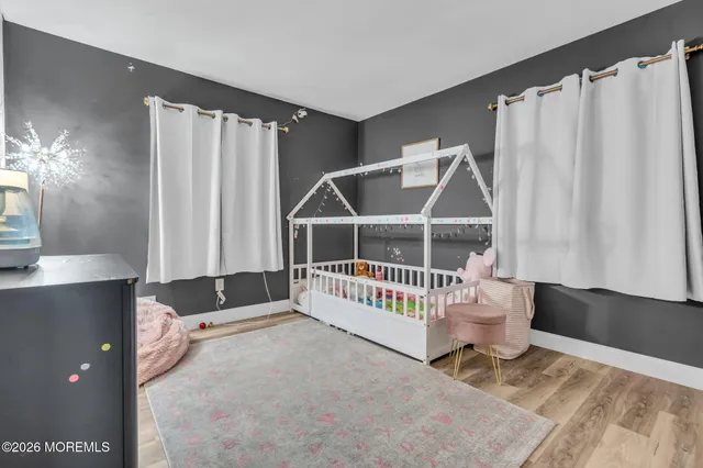 a view of a livingroom with wooden floor and white walls