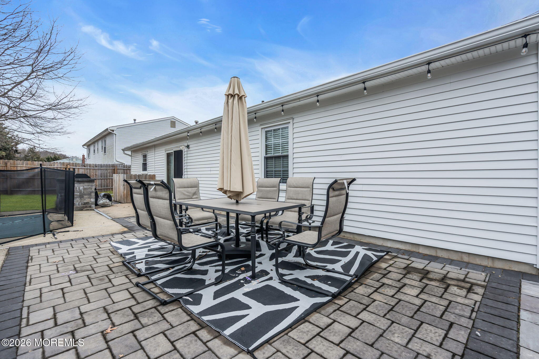 19 Virginia Drive Howell, NJ 07731 - Photo 37 of 39 a view of a patio with table and chairs and wooden fence