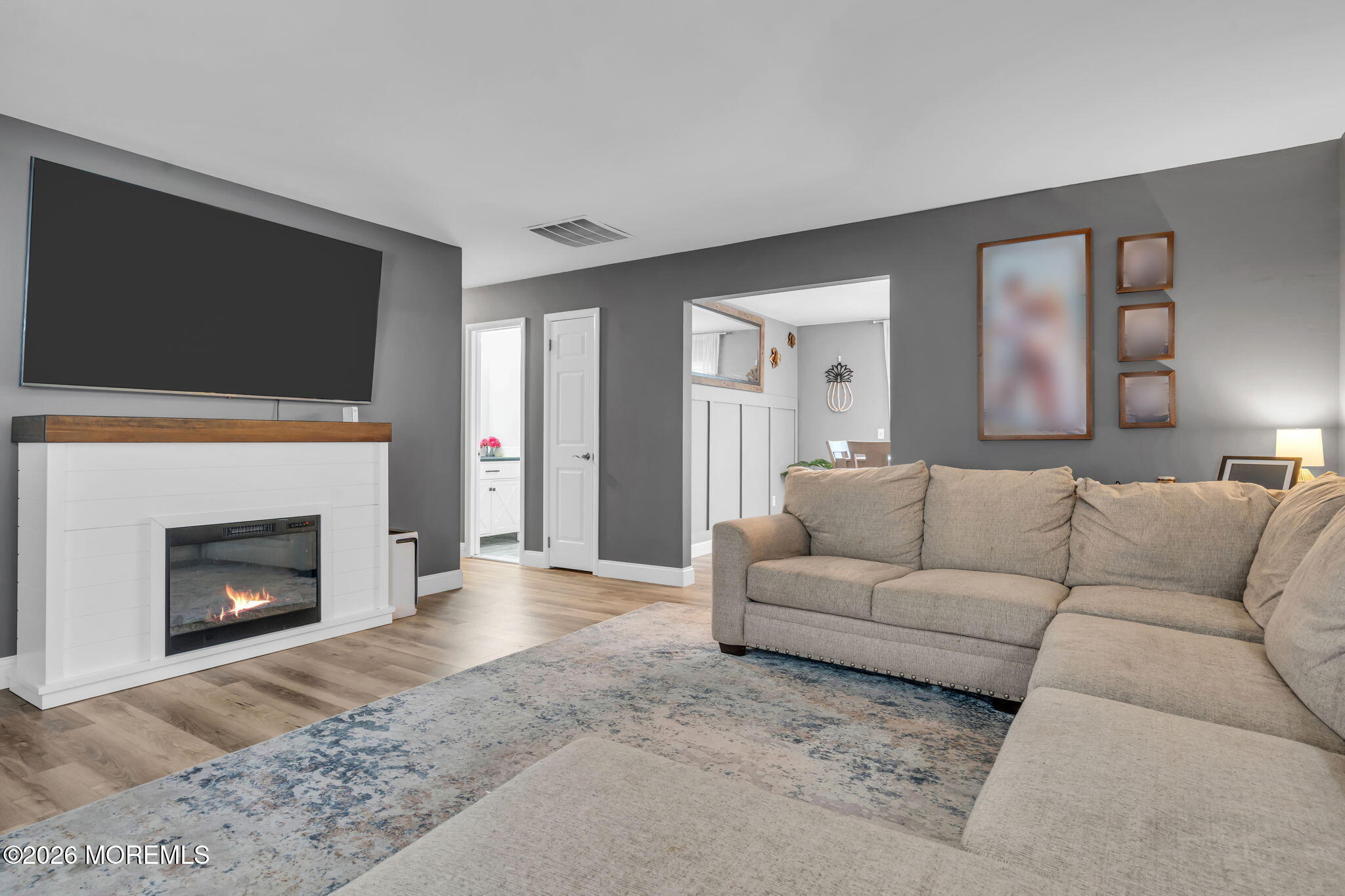 19 Virginia Drive Howell, NJ 07731 - Photo 9 of 39 a living room with furniture a fireplace and a flat screen tv