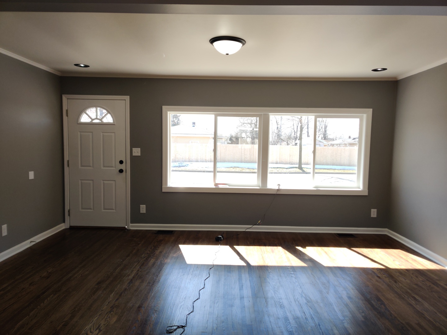 1101 Westminster Road Joliet, IL 60435 - Photo 2 of 17 a view of empty room with wooden floor and fan