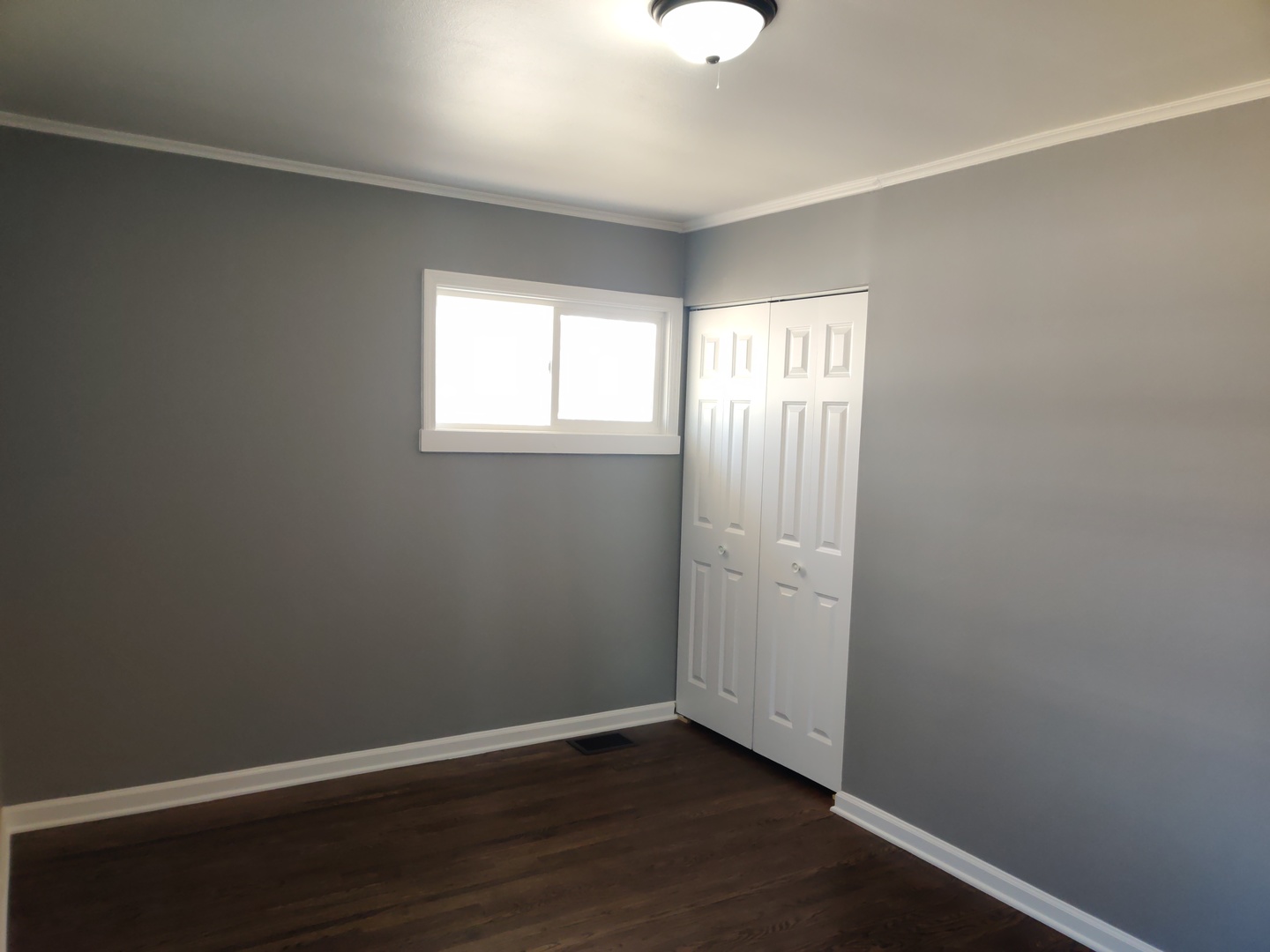 1101 Westminster Road Joliet, IL 60435 - Photo 9 of 17 an empty room with wooden floor and windows