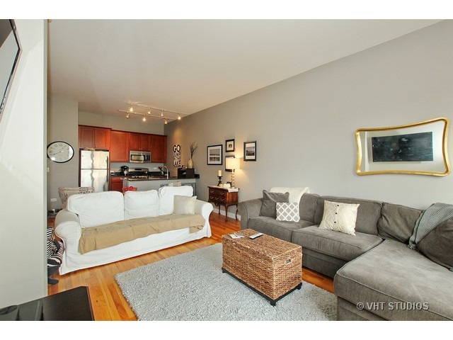 2025 South Indiana Avenue, Unit 211 Chicago, IL 60616 - Photo 2 of 10 a living room with furniture kitchen view and a couch