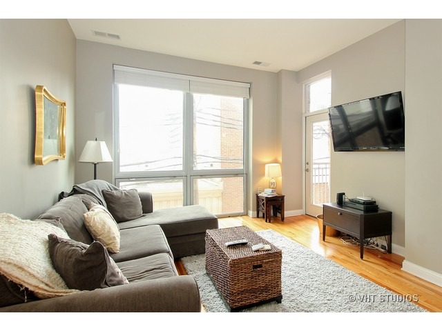 2025 South Indiana Avenue, Unit 211 Chicago, IL 60616 - Photo 3 of 10 a living room with furniture and a flat screen tv