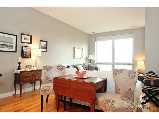 2025 South Indiana Avenue, Unit 211 Chicago, IL 60616 - Photo 7 of 10 a living room with furniture a large window and a lamp