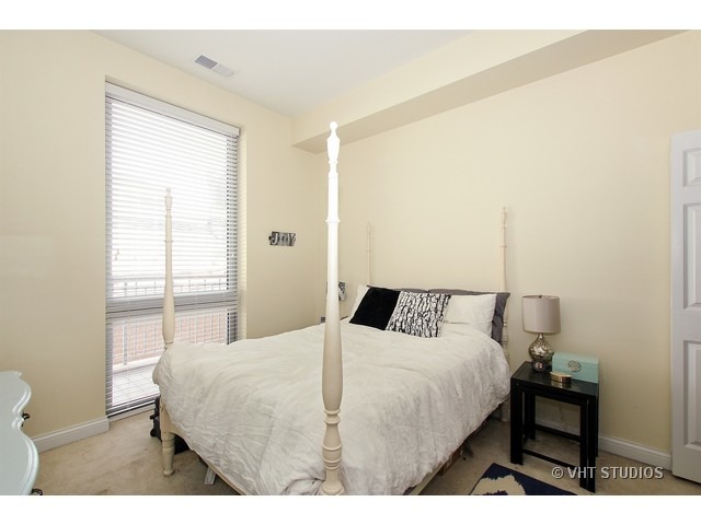 2025 South Indiana Avenue, Unit 211 Chicago, IL 60616 - Photo 8 of 10 a bedroom with a bed and a window