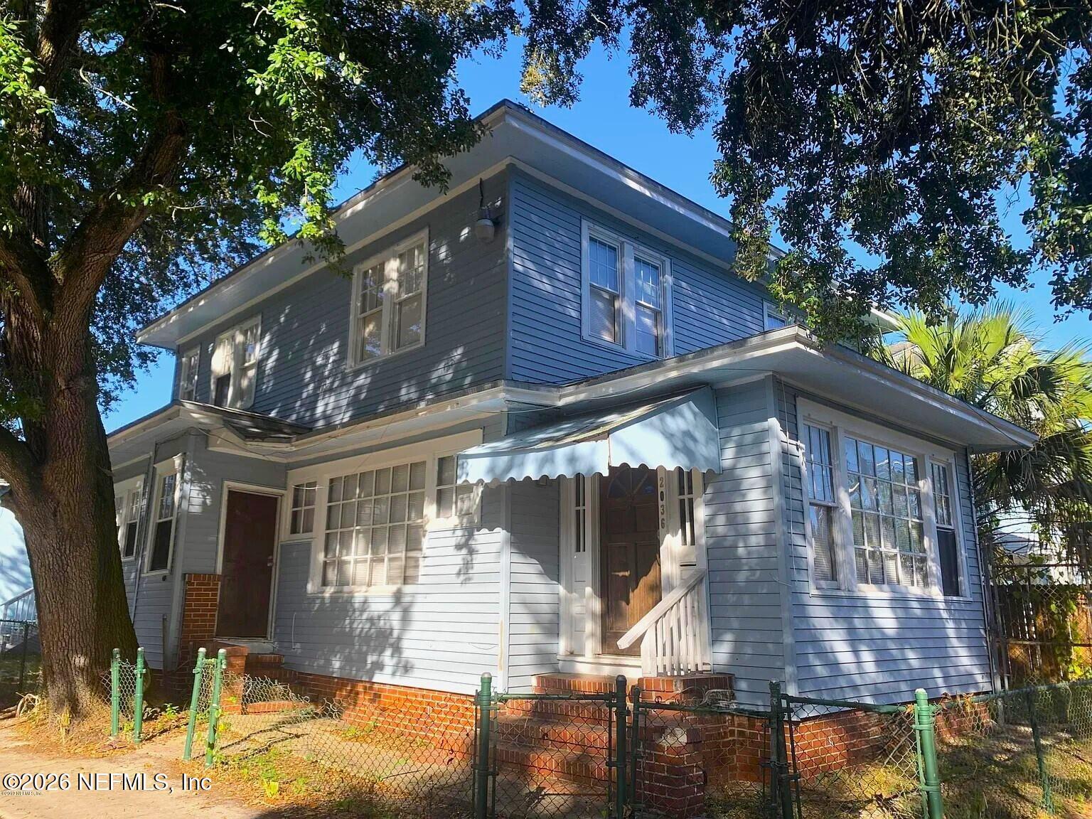 2036 Moncrief Road Jacksonville, FL 32209 - Photo 1 of 32 a front view of a house with a yard