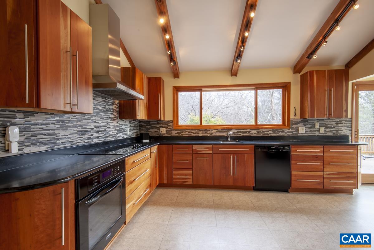 397 Rodes Valley Drive Nellysford, VA 22958 - Photo 11 of 46 a kitchen with granite countertop a sink and a stove