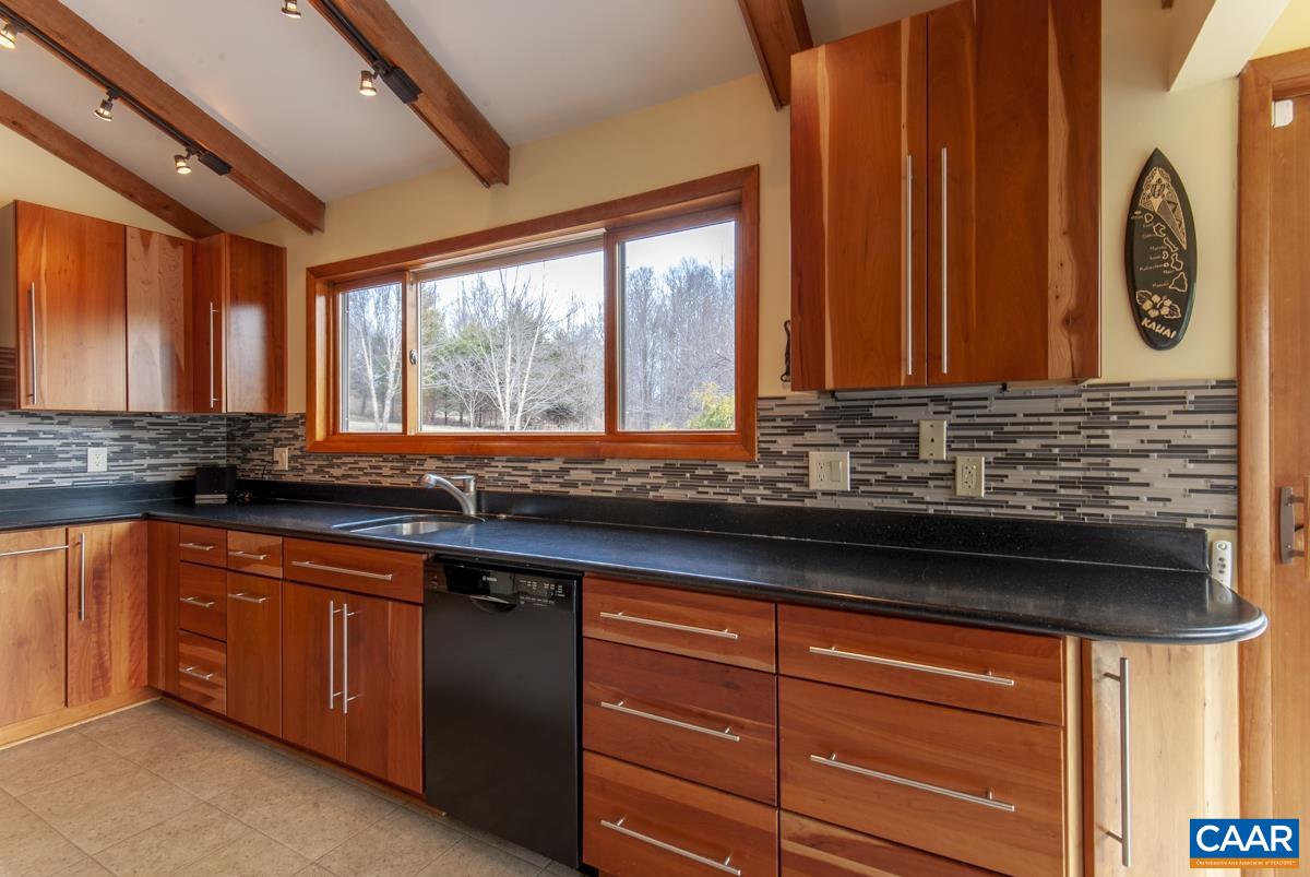 397 Rodes Valley Drive Nellysford, VA 22958 - Photo 13 of 46 a kitchen with stainless steel appliances granite countertop a sink and a granite counter tops