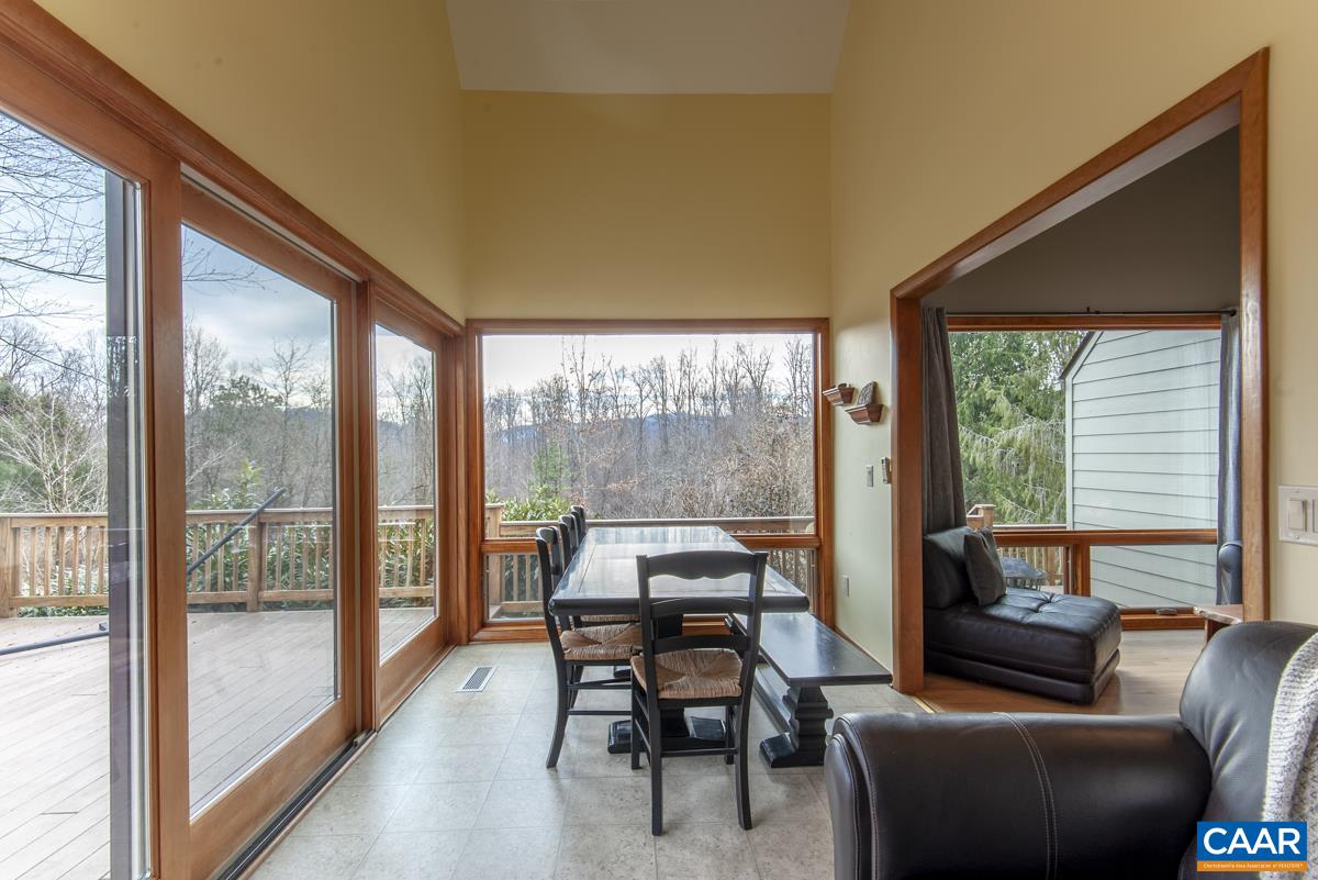 397 Rodes Valley Drive Nellysford, VA 22958 - Photo 16 of 46 a living room with furniture and a floor to ceiling window