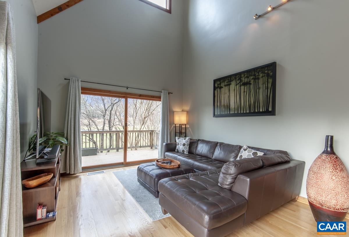 397 Rodes Valley Drive Nellysford, VA 22958 - Photo 20 of 46 a living room with furniture and a large window