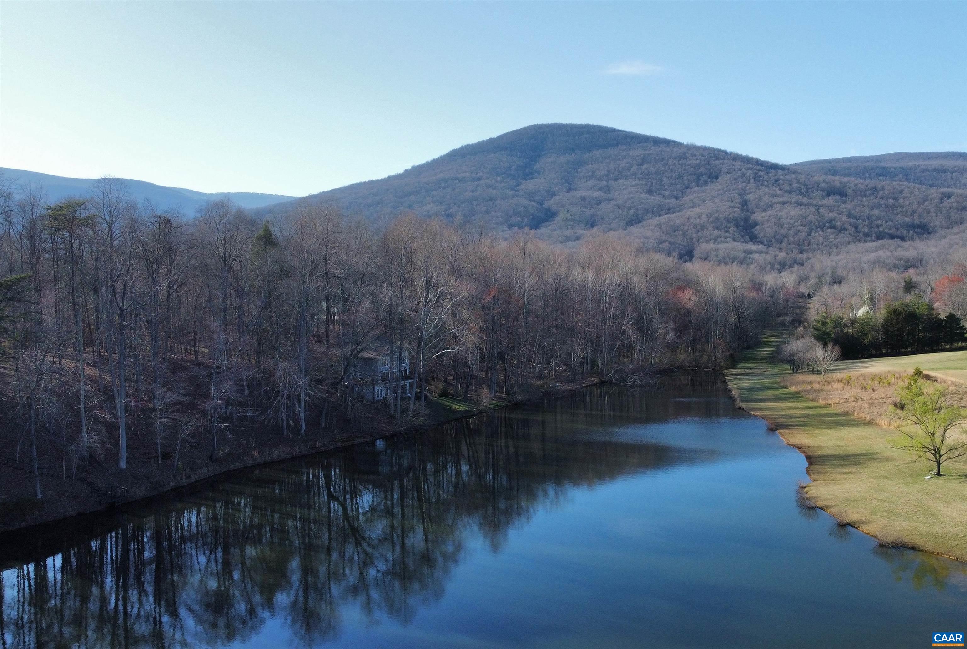 397 Rodes Valley Drive Nellysford, VA 22958 - Photo 2 of 46 a view of a lake in middle of forest