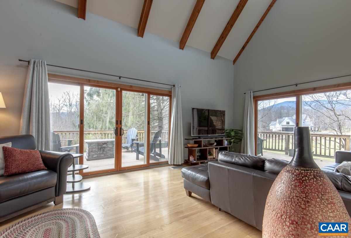 397 Rodes Valley Drive Nellysford, VA 22958 - Photo 22 of 46 a living room with furniture and a flat screen tv