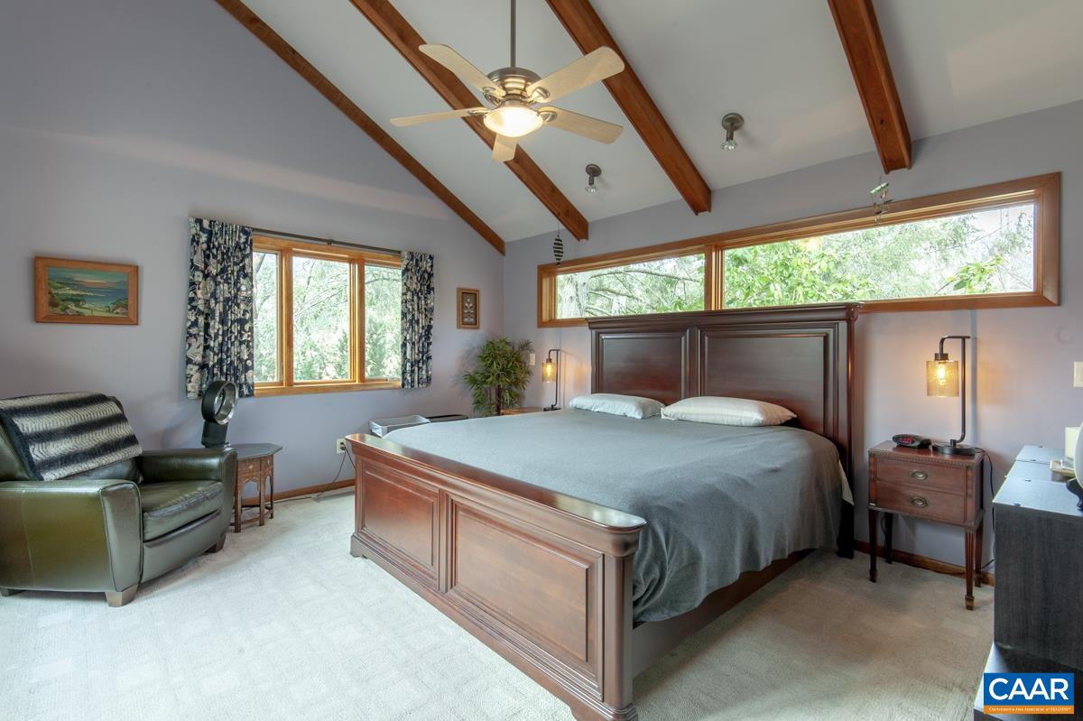 397 Rodes Valley Drive Nellysford, VA 22958 - Photo 27 of 46 a bedroom with a bed couch and window