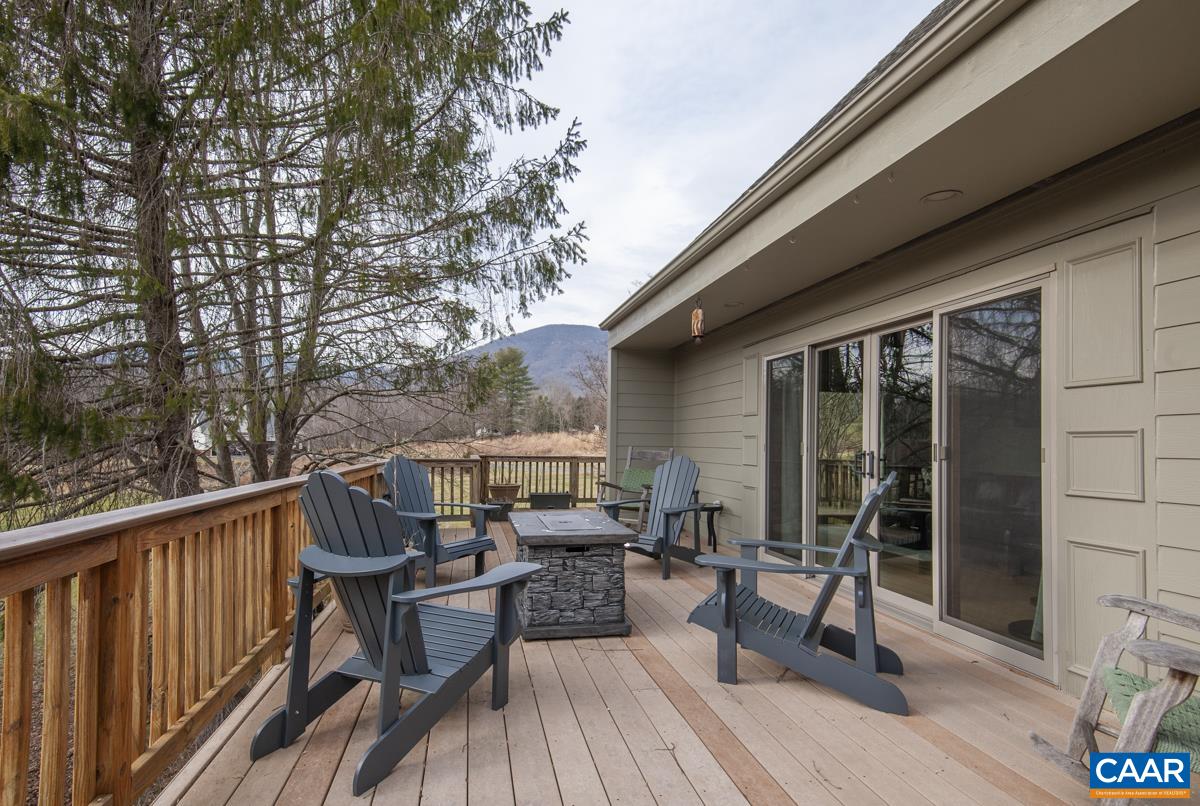 397 Rodes Valley Drive Nellysford, VA 22958 - Photo 3 of 46 a view of balcony with chairs and wooden fence