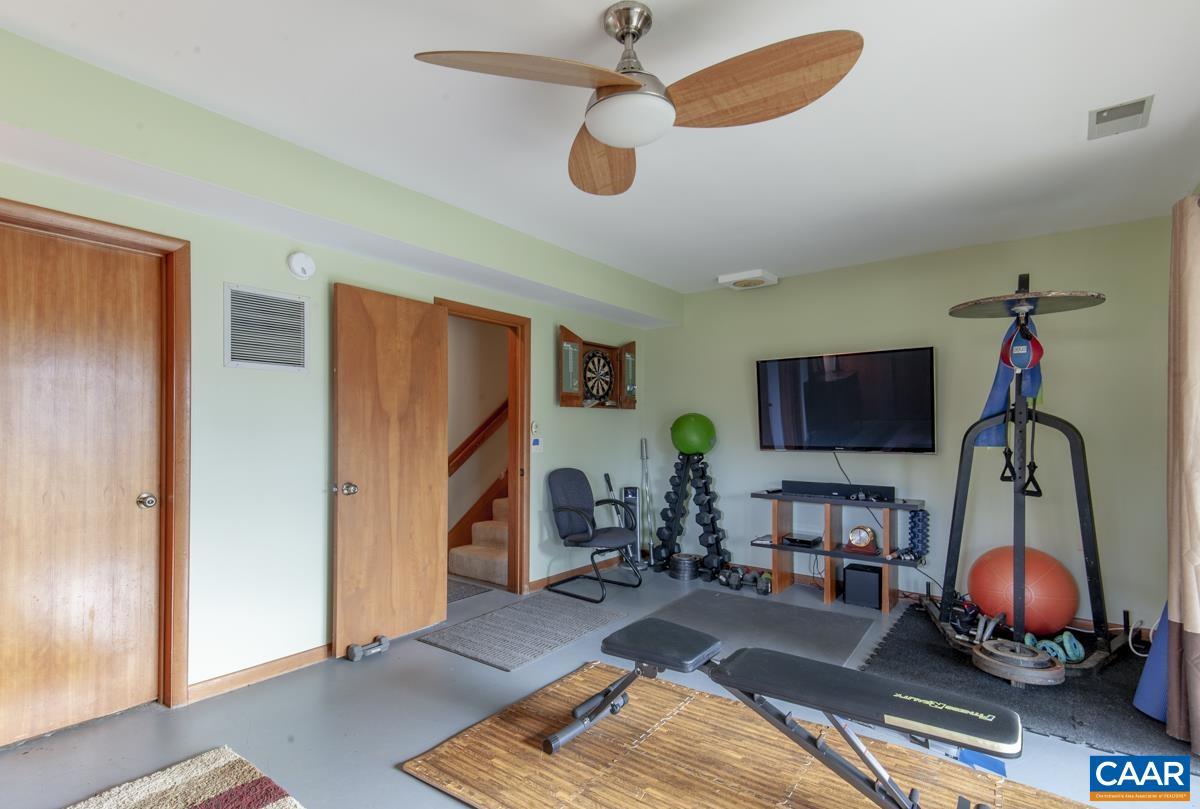 397 Rodes Valley Drive Nellysford, VA 22958 - Photo 33 of 46 a living room with furniture and a flat screen tv