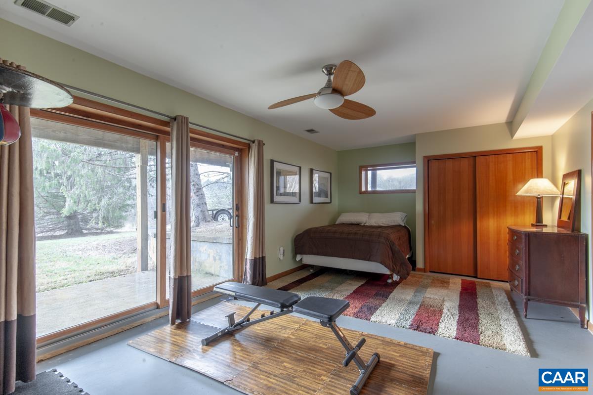397 Rodes Valley Drive Nellysford, VA 22958 - Photo 34 of 46 a bedroom with a bed and wooden floor