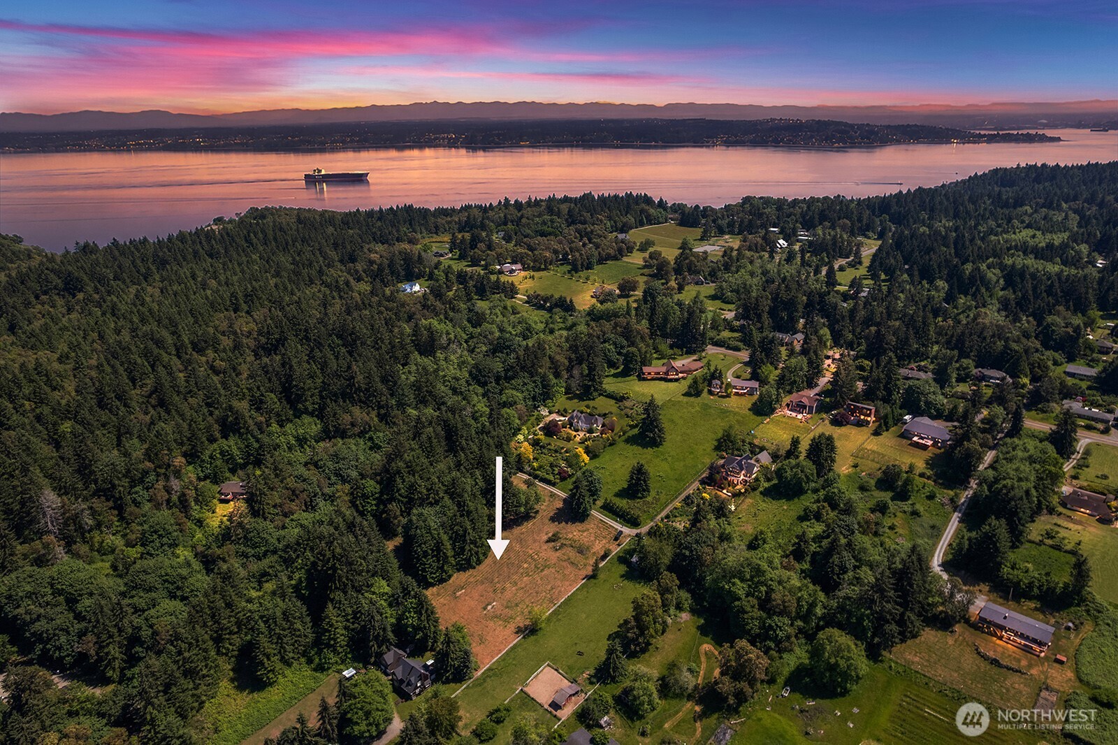 9438 Southwest 266th Lane Vashon, WA 98070 - Photo 1 of 24 a view of a city and sunset