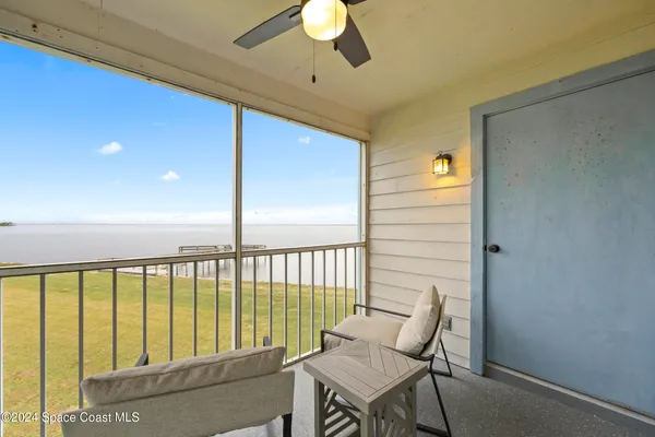 a view of a balcony with furniture