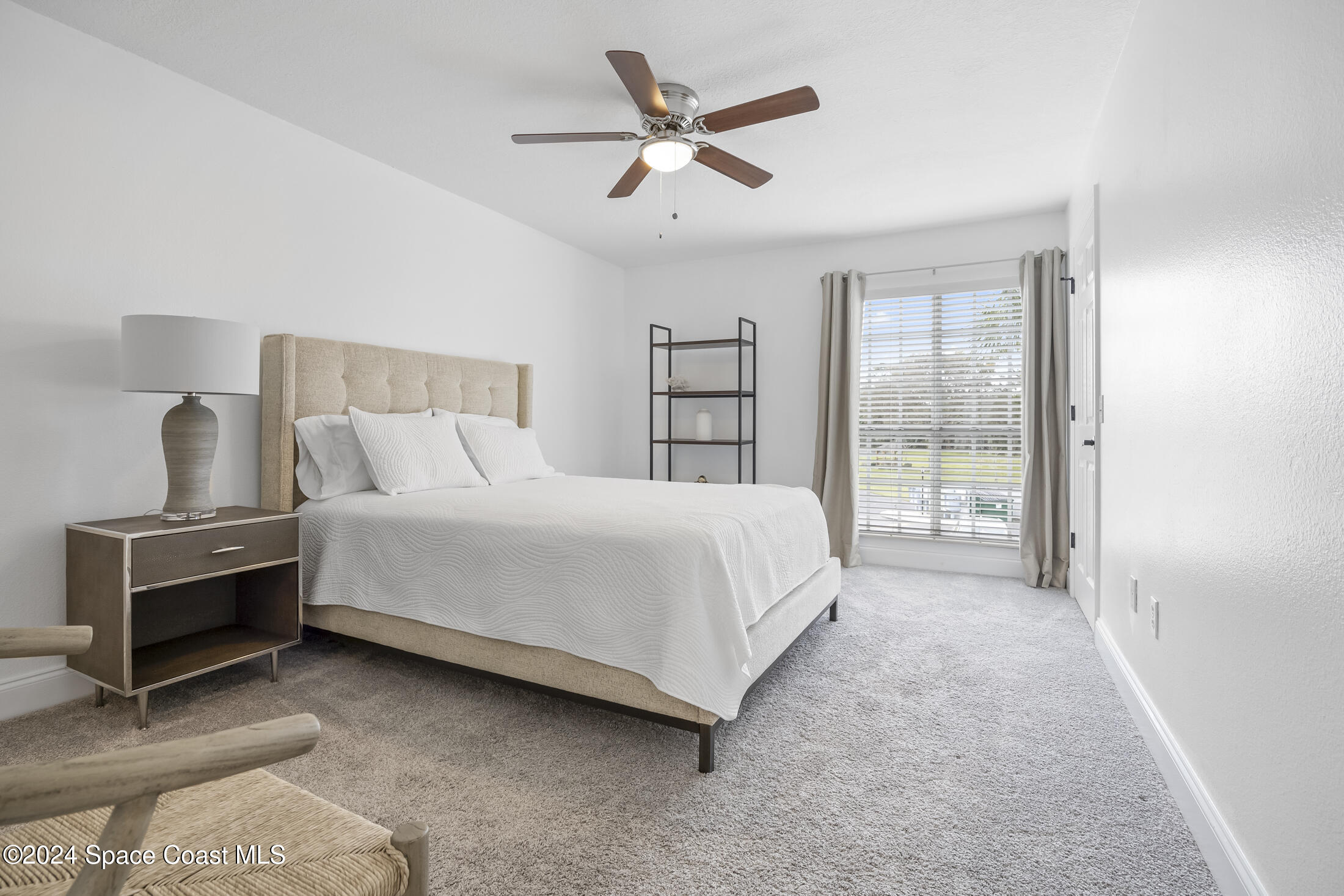 7030 N Highway, Unit DD205 Cocoa, FL 32927 - Photo 22 of 34 a large bed sitting in a bedroom next to a window