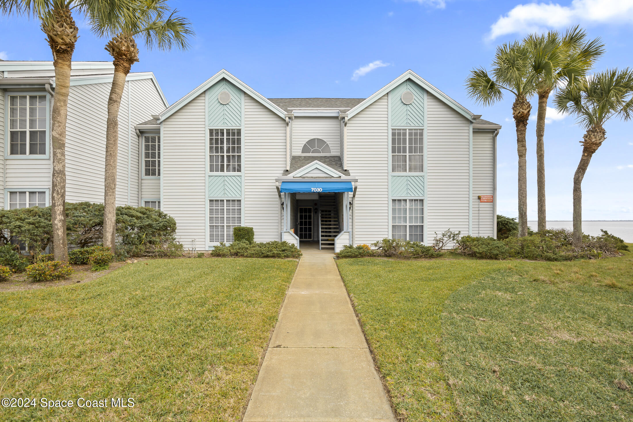 7030 N Highway, Unit DD205 Cocoa, FL 32927 - Photo 3 of 34 a front view of a house with garden