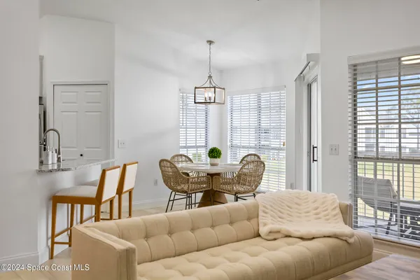 a dining room with furniture and window