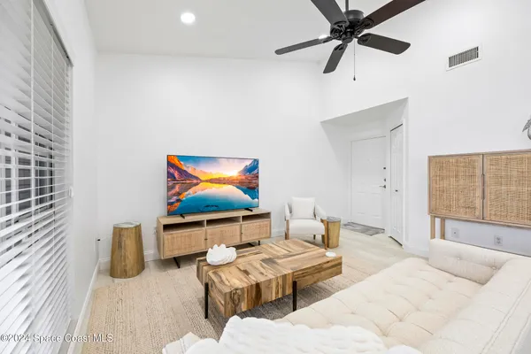 a bedroom with furniture and a flat screen tv