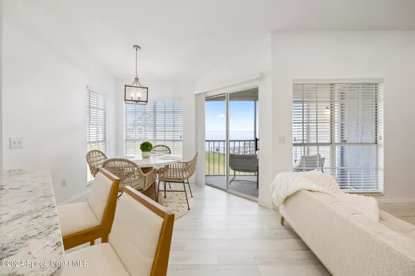 a living room with furniture a window and wooden floor