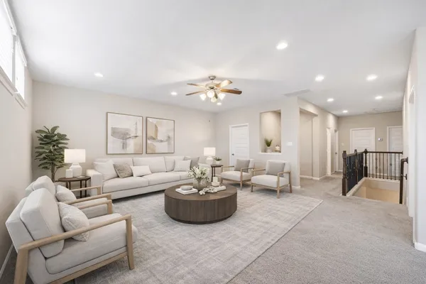 a living room with furniture and a chandelier