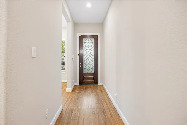 a view of a hallway with wooden floor