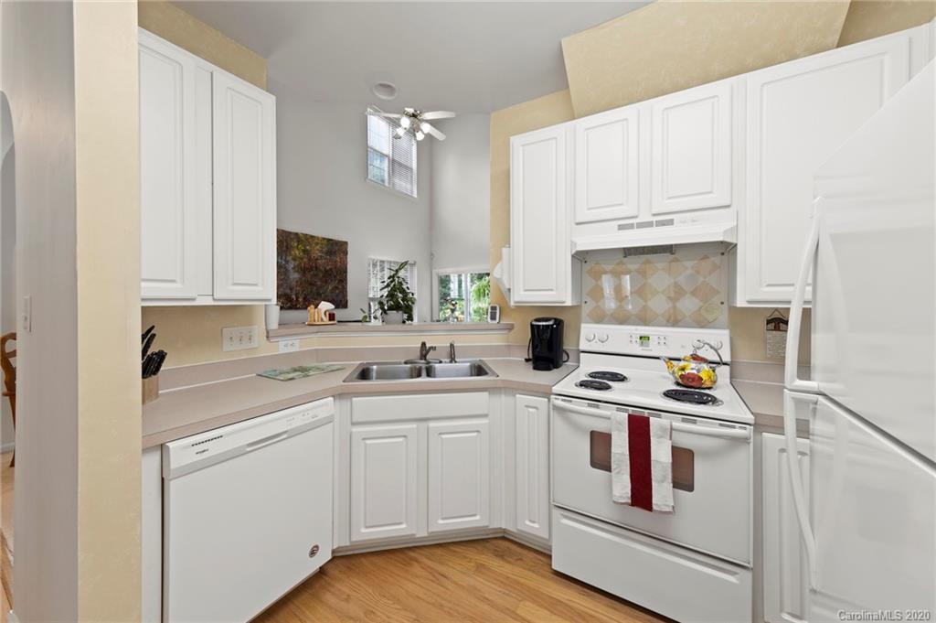2511 Fossil Stone Lane Fort Mill, SC 29708 - Photo 13 of 34 a kitchen with white cabinets and white appliances