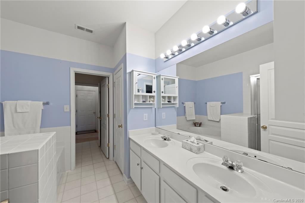 2511 Fossil Stone Lane Fort Mill, SC 29708 - Photo 17 of 34 a spacious bathroom with a double vanity sink and a mirror