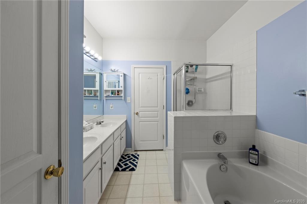 2511 Fossil Stone Lane Fort Mill, SC 29708 - Photo 18 of 34 a bathroom with a bathtub sink and mirror
