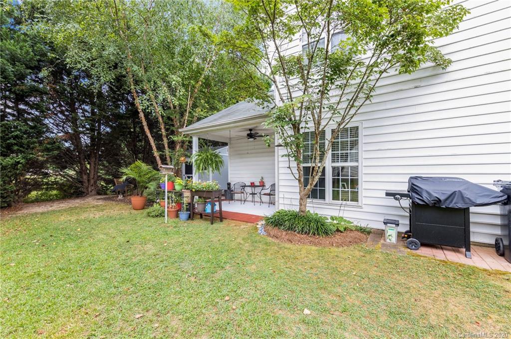 2511 Fossil Stone Lane Fort Mill, SC 29708 - Photo 34 of 34 a view of a backyard with table and chairs and a large tree
