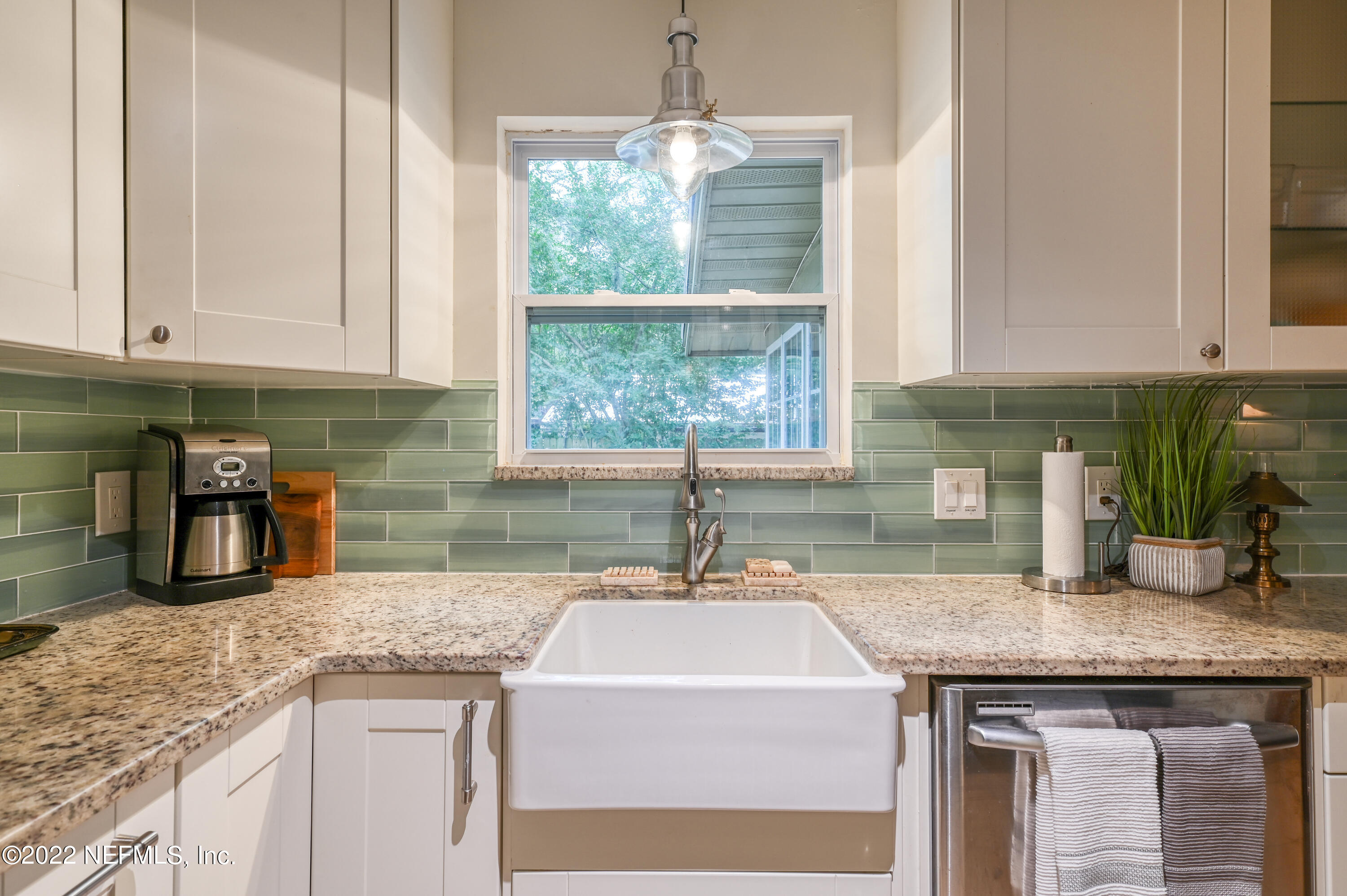 513 Jasmine Road St. Augustine, FL 32086 - Photo 12 of 37 a kitchen with granite countertop a sink window and cabinets