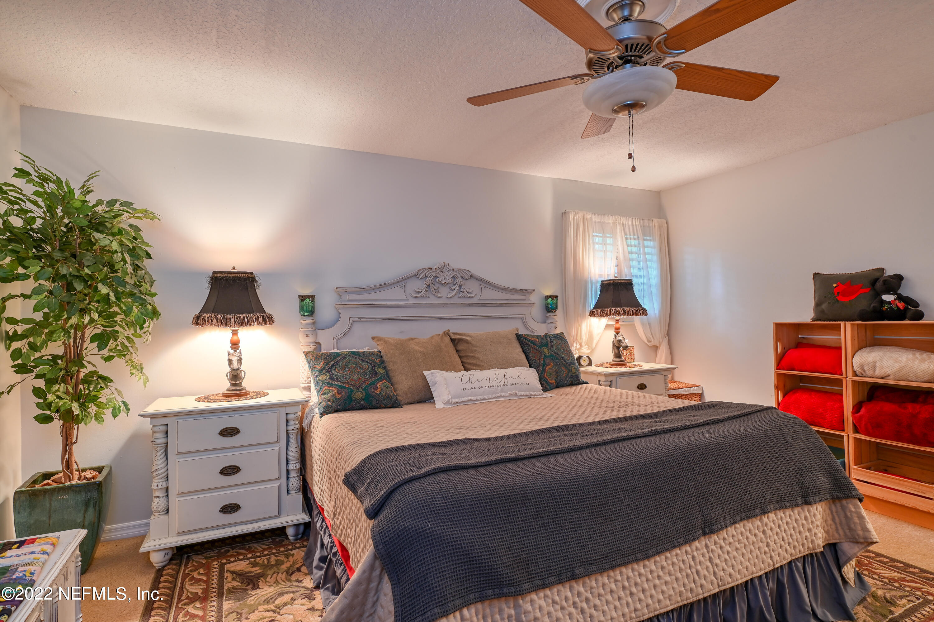 513 Jasmine Road St. Augustine, FL 32086 - Photo 17 of 37 a bedroom with a bed and a chandelier