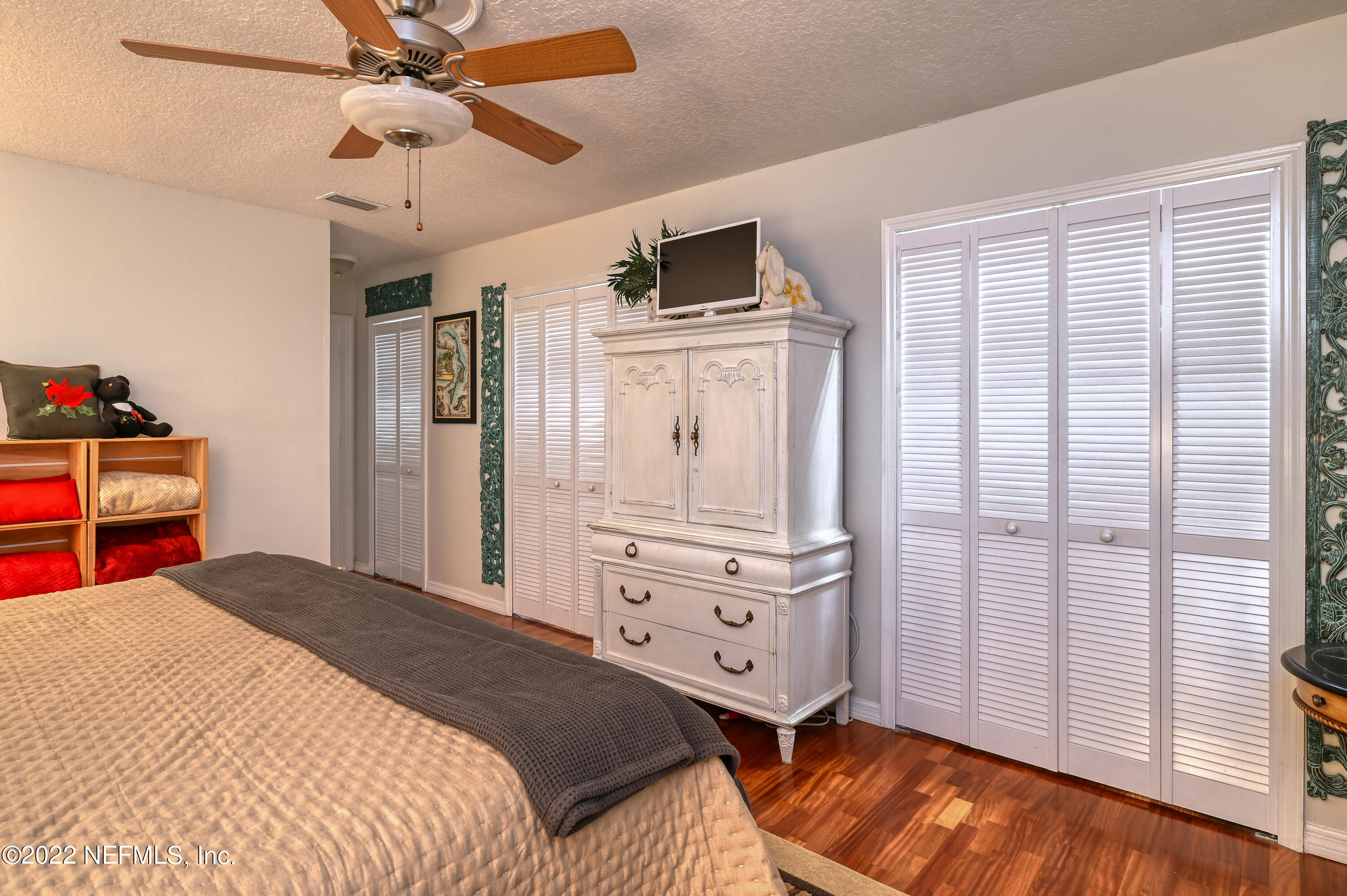 513 Jasmine Road St. Augustine, FL 32086 - Photo 18 of 37 a bedroom with a bed and a chandelier