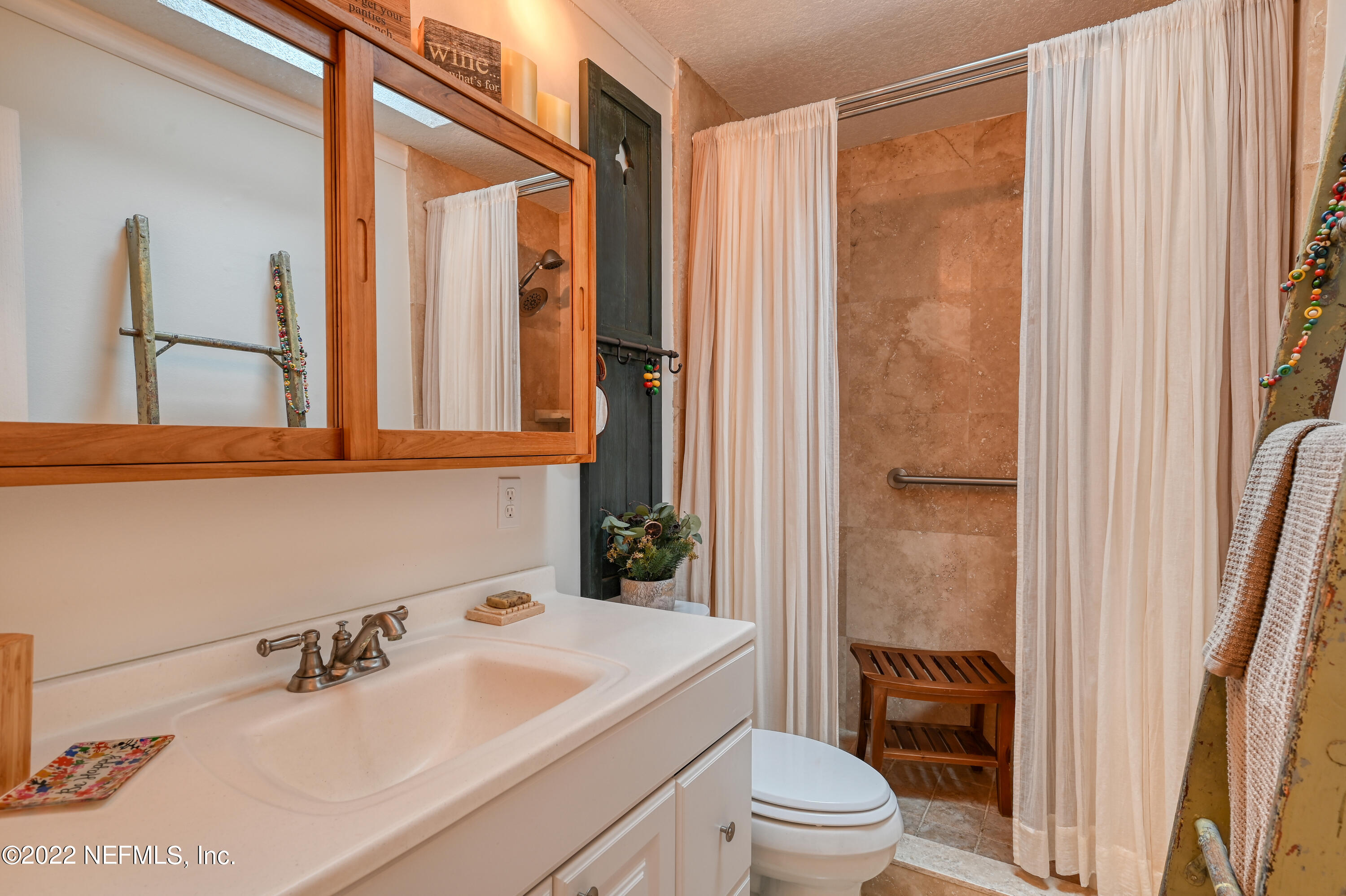 513 Jasmine Road St. Augustine, FL 32086 - Photo 19 of 37 a bathroom with a sink a toilet and a mirror