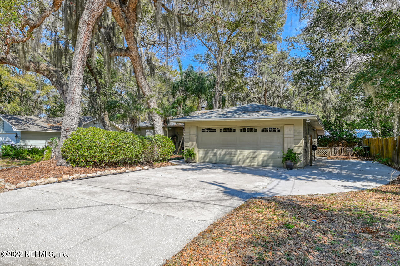 513 Jasmine Road St. Augustine, FL 32086 - Photo 3 of 37 a view of a house with a yard and garage