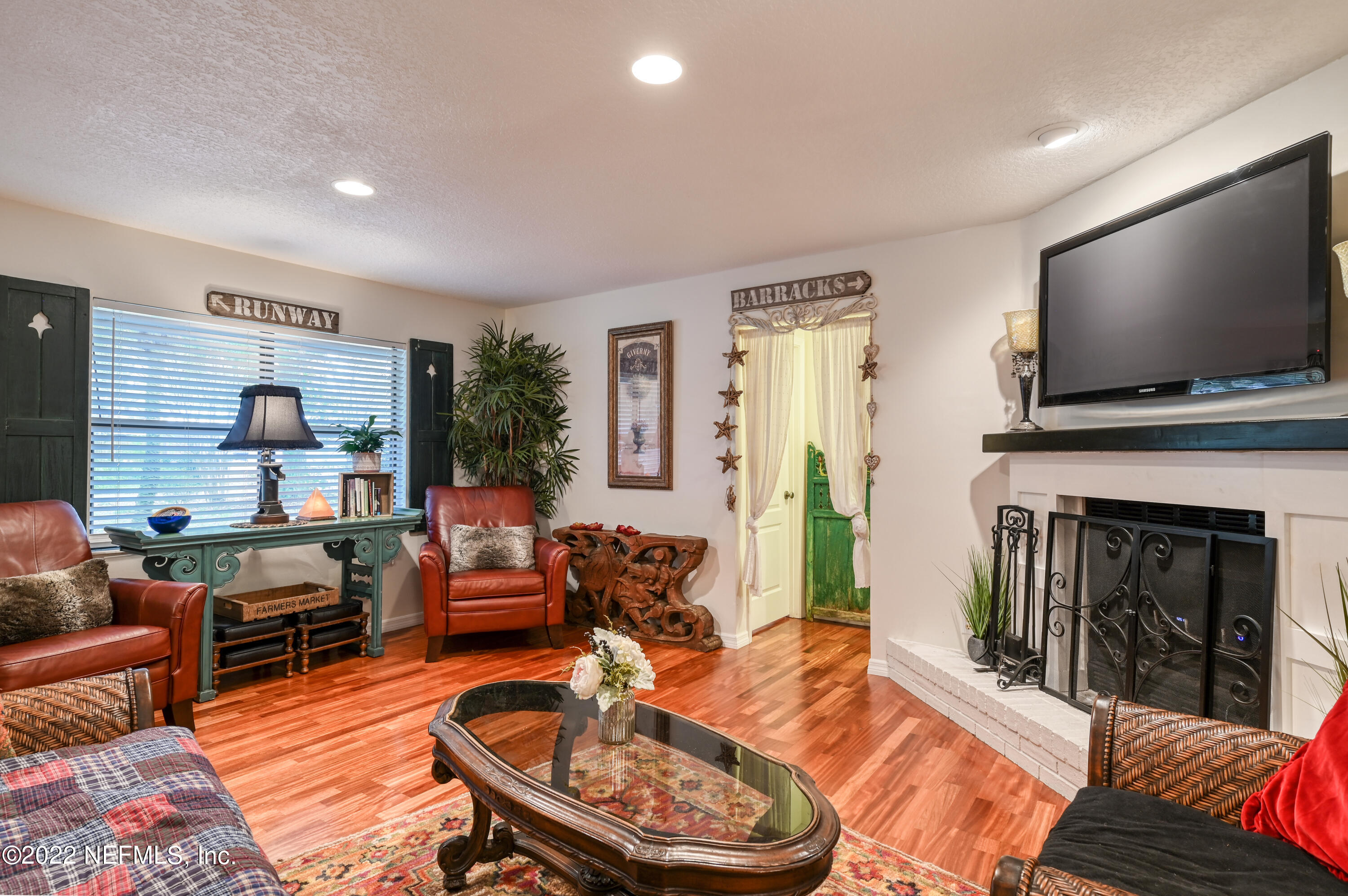 513 Jasmine Road St. Augustine, FL 32086 - Photo 8 of 37 a living room with fireplace furniture and a flat screen tv