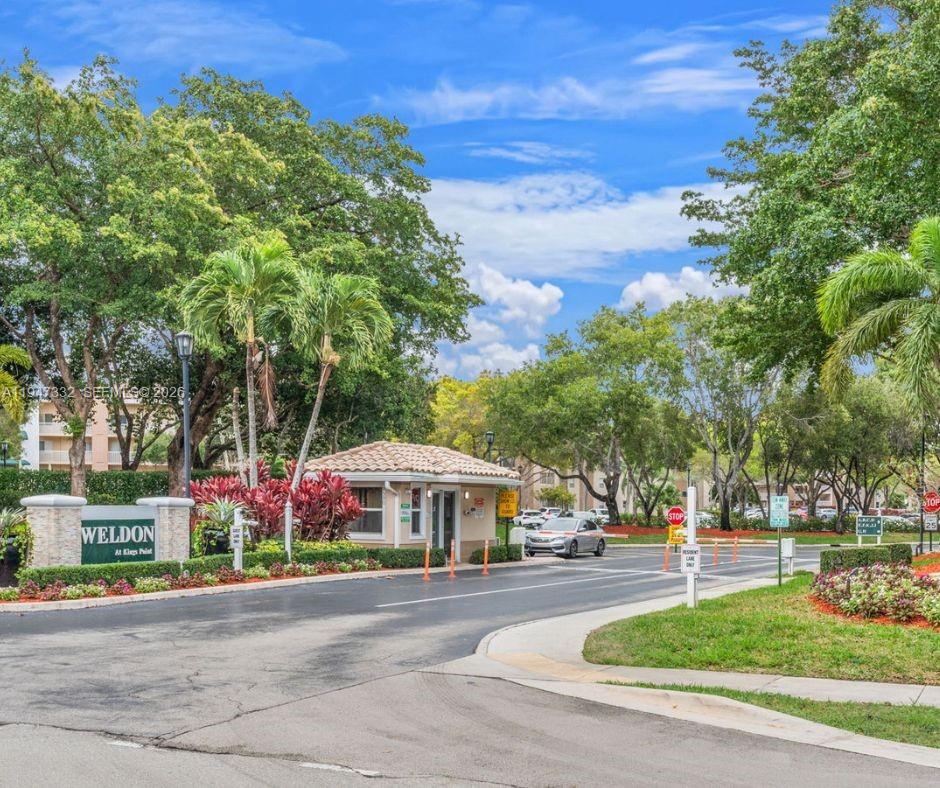 a front view of a building with trees