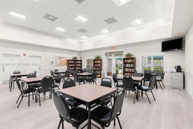 a view of a swimming pool with a yard and plants