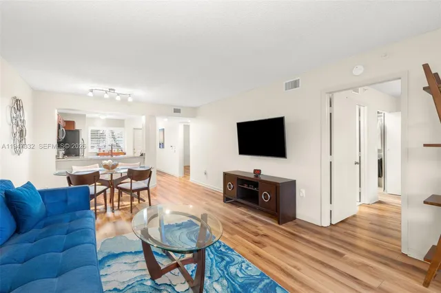 a view of a dining room with furniture and a chandelier