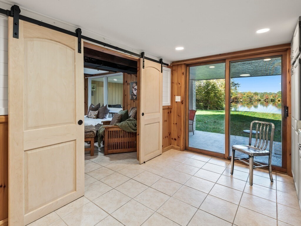 6 Winding Cove Road Ashburnham, MA 01430 - Photo 26 of 40 a living room with furniture and a floor to ceiling window