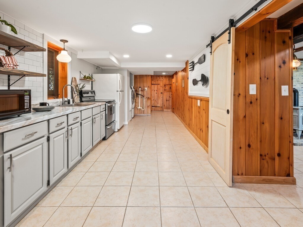6 Winding Cove Road Ashburnham, MA 01430 - Photo 27 of 40 a large white kitchen with a sink and cabinets