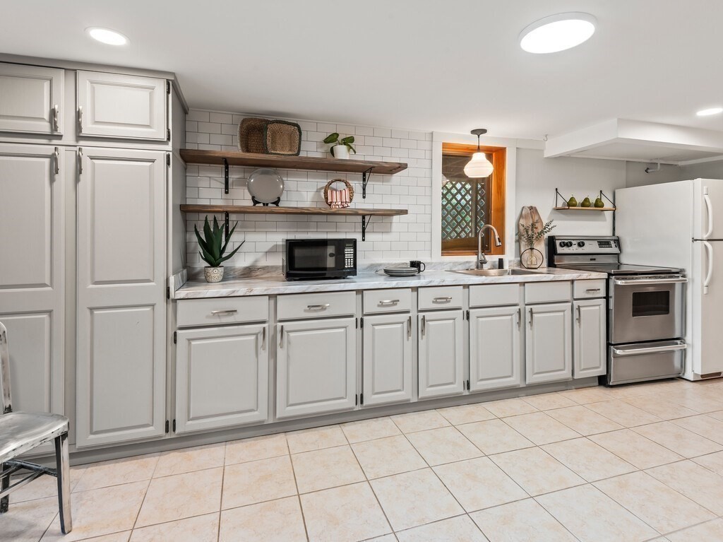 6 Winding Cove Road Ashburnham, MA 01430 - Photo 28 of 40 a kitchen with white cabinets appliances and sink