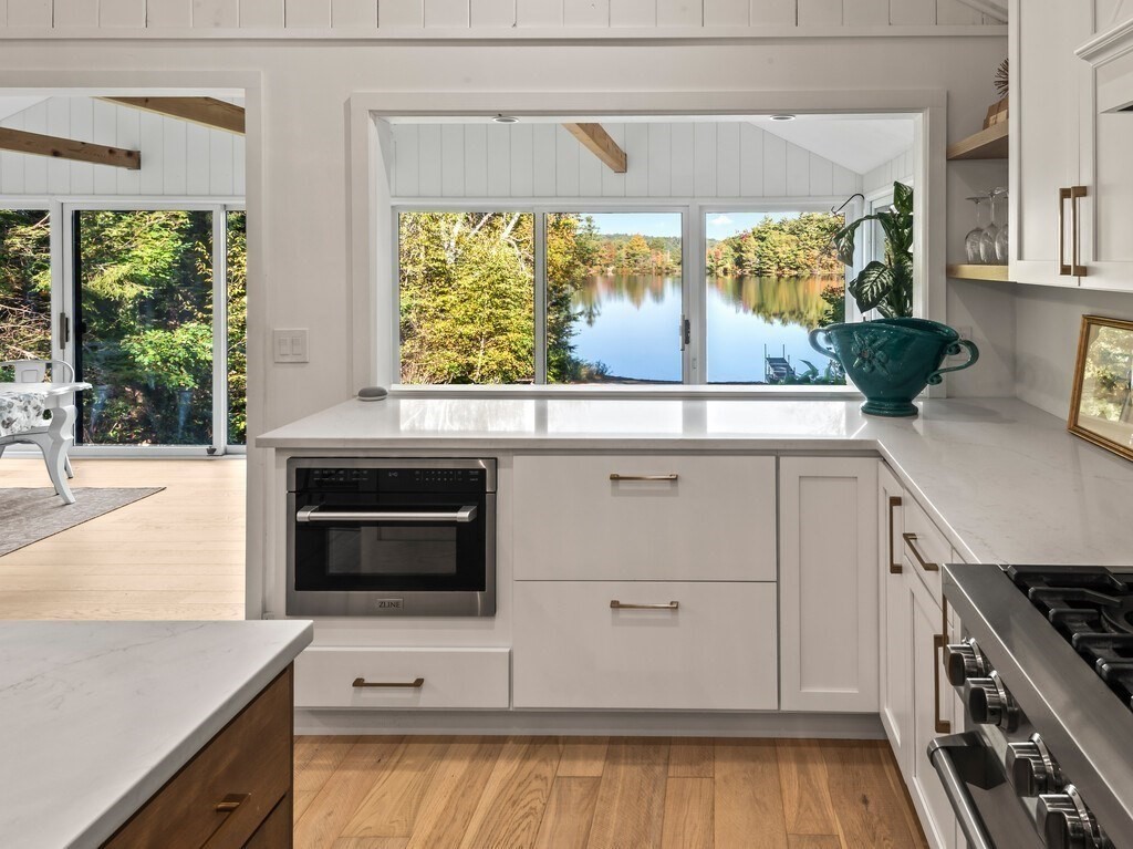 6 Winding Cove Road Ashburnham, MA 01430 - Photo 6 of 40 a kitchen with stainless steel appliances wooden floor sink and wooden cabinets